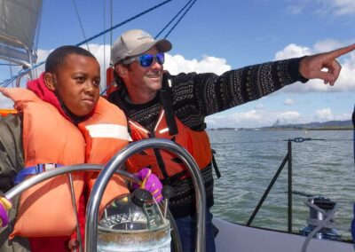 Pegasus Captain supervising schoolchild at the helm of the ship